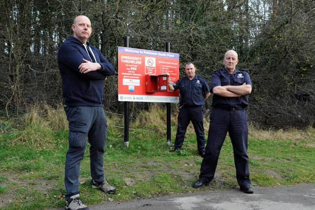 Cllr Tony Taylor with Tyne and Wear Fire and Rescue Service's Mark Hayes and Tommy Richardson alongside the damaged throw line box at Pattinson South Pond, Washington.