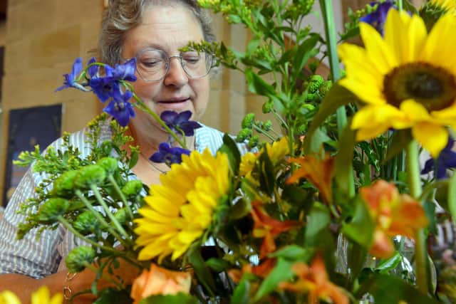 Gwen Young arranging flowers at the church