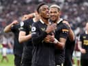 Joe Willock of Newcastle United celebrates after scoring their team's first goal during the Premier League match between West Ham United and Newcastle United at London Stadium on February 19, 2022 in London, England. (Photo by Warren Little/Getty Images)