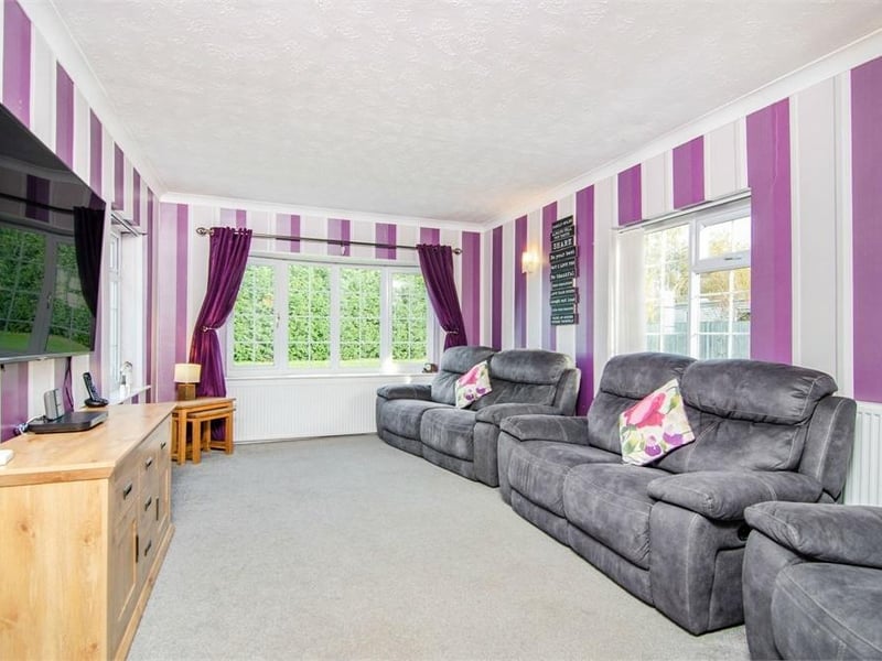 The cosy living room has a front aspect window and two additional side aspect windows