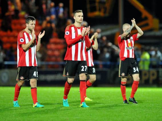 Sunderland's players applaud the travelling supporters.