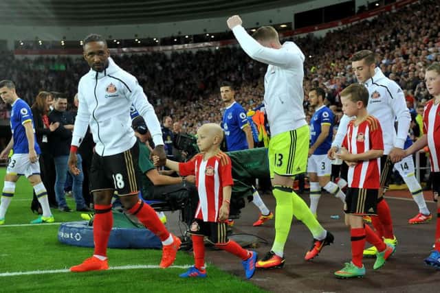 Bradley walks out onto the pitch with Jermain Defoe.