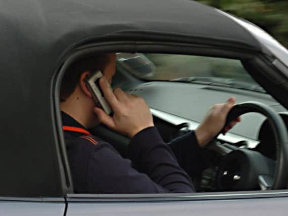 Would you tell this driver to put his phone down?