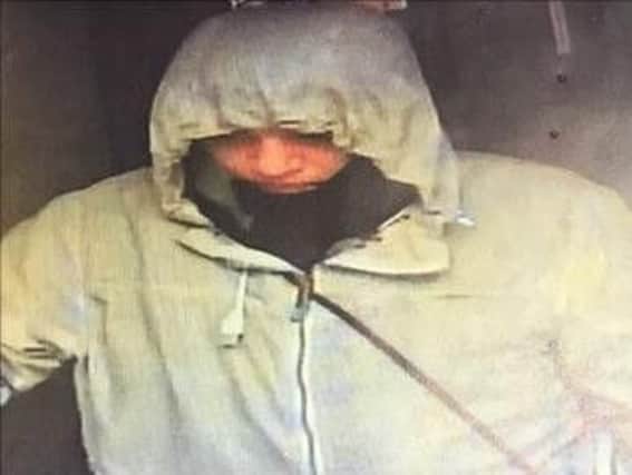 Police want to speak to this man who may be able to help with their investigation after the Domino's Pizza shop in Houghton was robbed at gunpoint.