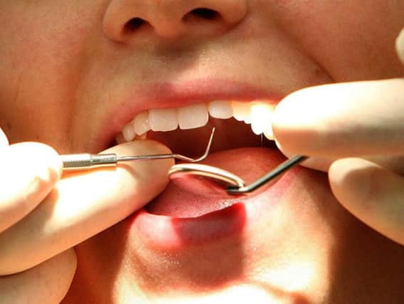 A dentist at work, as figures show that the number of tooth extractions in hospital for children aged four and under has risen by almost a quarter in the last decade. Picture by PA.
