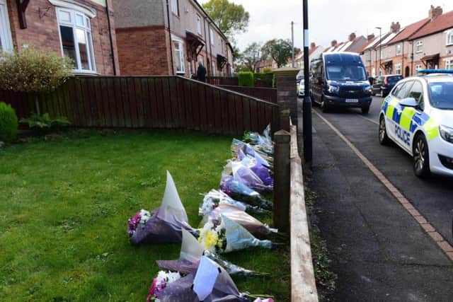 Floral tributes left outside the house in Shrewsbury Crescent in which the bodies of Alan Martin and Kay Martin were found.