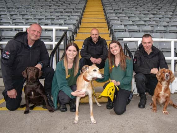 Police officers and Dogs' Trust staff with some of the recruits.