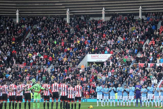 Teams observe a silence at a previous Remembrance Service at the Stadium of Light.