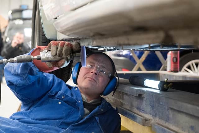 Colin Robinson repairing vehicle