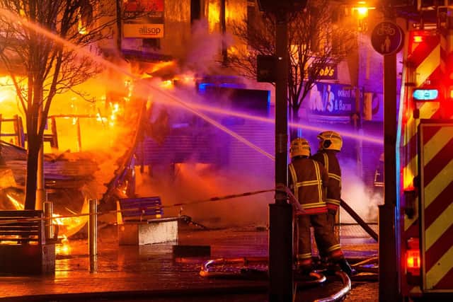 Firefighters tackle the blaze at Peacocks last night. Picture by RYAN LIM.