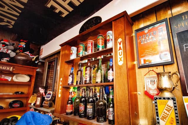 The collection includes pub signs, trays and beer mats.