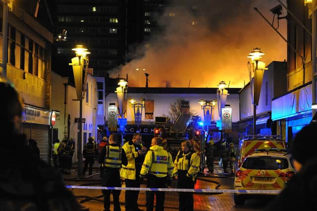 Police on the scene of the Peacocks fire as it raged through the building.
