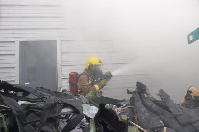 A firefighter tackles the incident.