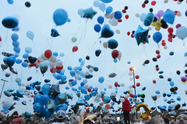 Balloons fill the sky and spread their message.