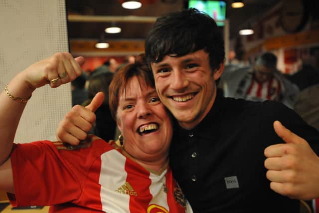 Delighted fans celebrate at Quinn's Bar at the Stadium of Light