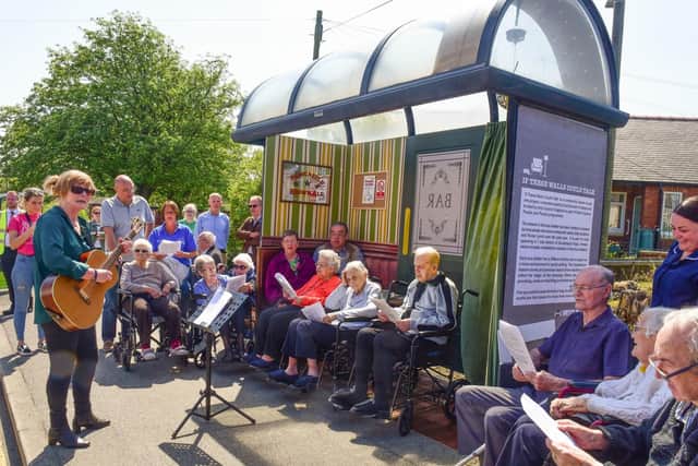 Local singer Celia Bryce having a sing-a-long with residents at Bus Stop 1 'Social Club' during the pop-up art in Sunderland Road, Horden.
