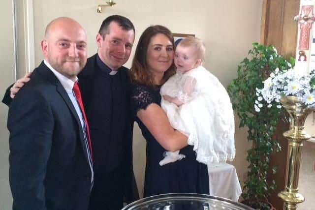 Chris Corr, Fr Marc Lyden-Smith and Emma Corr pictured on the Christening day of Harriet Corr, now aged four.