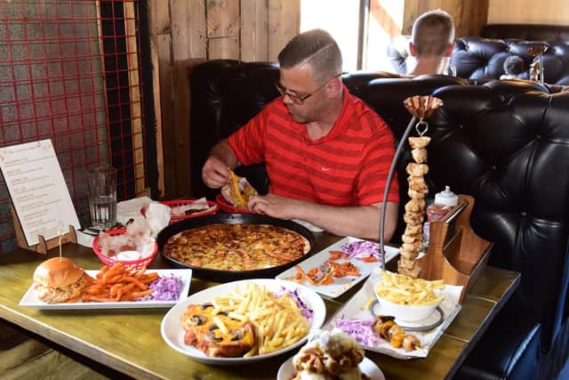 Fellow competitor Ross Appleby tucks into his feast at The Meat Up bar & Grill.