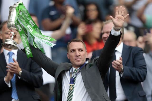 Celtic manager Brendan Rodgers lifts the trophy after winning the William Hill Scottish Cup Final.
