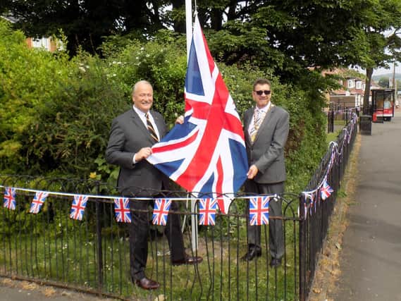 Graeme Hall, of the Armed Forces Network and Deputy Mayor, Coun David Snowdon, raising the flag.