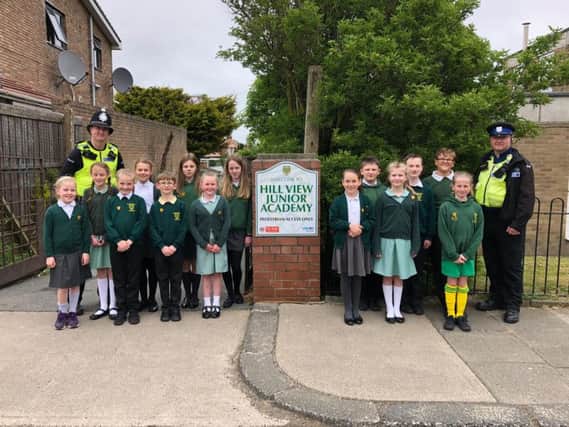 PC Adam Carlton (left) and Community Support Officer Allan Postings (right) with children from Hill View Junior Academy.