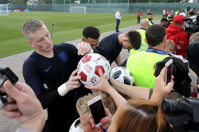 Jordan Pickford signs autographs for fans in Russia ahead of tonight's World Cup opener against Tunisia.