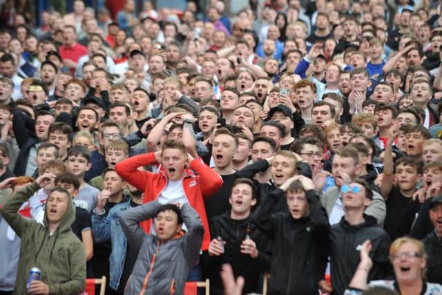 Fans watch England's opening World Cup match against Tunisia, at Sunderland's Park Lane Fanzone.
