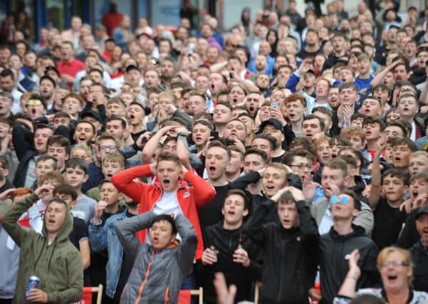 Fans watch England's opening World Cup match against Tunisia, at Sunderland's Park Lane Fanzone.
