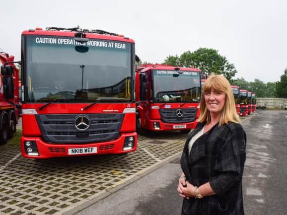 Cabinet Member for Environment and Transport, Councillor Amy Wilson, with some of the new recycling vehicles.