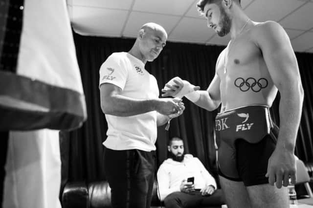 Kelly getting wrapped pre-fight by Booth.