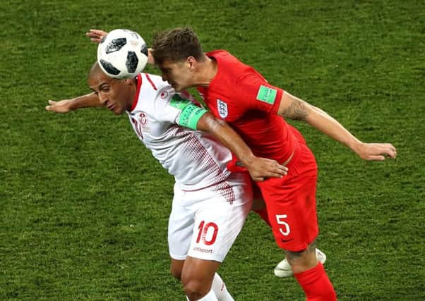 Wahbi Khazri battles against England's John Stones in Monday's World Cup Group G clash