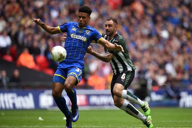 AFC Wimbledon's Lyle Taylor (left) and Plymouth Argyle's Peter Hartley battle for the ball during the Sky Bet League Two Play-Off Final match at Wembley Stadium, London. PRESS ASSOCIATION Photo. Picture date: Monday May 30, 2016. See PA story SOCCER League Two. Photo credit should read: Andrew Matthews/PA Wire. RESTRICTIONS: EDITORIAL USE ONLY No use with unauthorised audio, video, data, fixture lists, club/league logos or "live" services. Online in-match use limited to 75 images, no video emulation. No use in betting, games or single club/league/player publications.