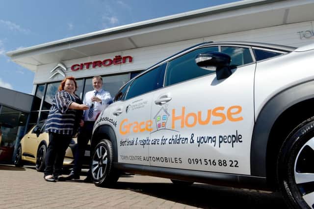 Karen Maclennan from Grace House is presented with the keys to the car by Chris Sopp (Dealer principle town centre Citroen). Picture by FRANK REID