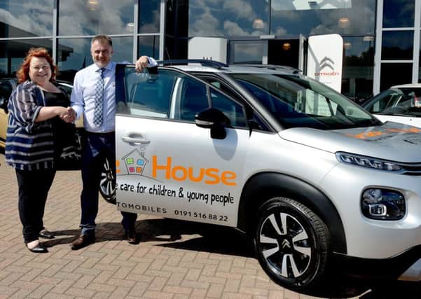 Karen Maclennan from Grace House is presented with the keys to the car by Chris Sopp (Dealer principle town centre Citroen). Picture by FRANK REID
