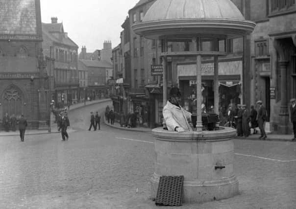 A familiar scene in bygone Durham with the police box in the foreground and Doggarts in the distance.