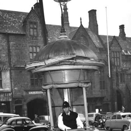 The traffic control box in the centre of Durham City, with the Market Place in the background.