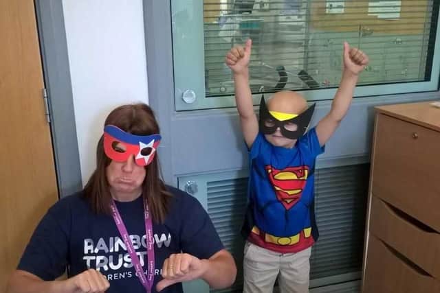 Superhero Bradley Lowery with a Rainbow Trust worker.