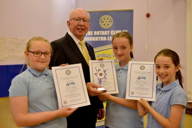 Kaydie Webb, centre, is presented with her photography trophy and certificate by Ashley Burland president of Houghton-Le-Spring Rotary Club as fellow award winners Lacey Raine, left, and Isabel Davison hold their certificates.