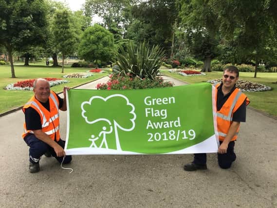 Flying the flag in Mowbray Park are council environment and grounds staff Iain Worthy (left) and Eddie Campbell.