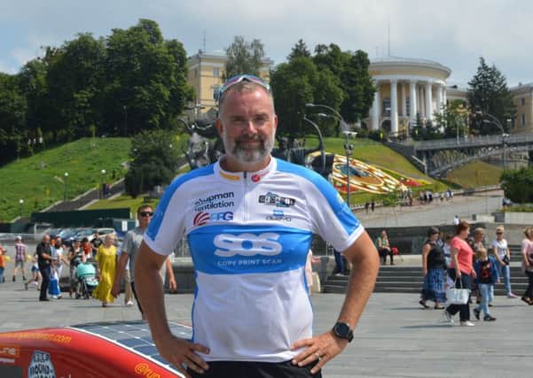 Mark Allison in Kiev at the end of the latest stage of his round the world run.