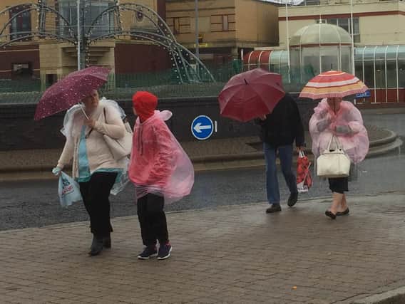 Umbrellas were the order of the day for airshow visitors on the blustery, rainswept seafront.