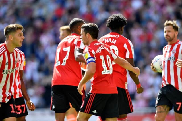 Josh Maja gets mobbed by his team-mates after pulling Sunderland level.