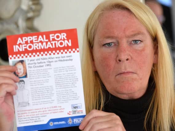 Sharon Henderson pictured with a leaflet issued by Northumbria Police as part of the fresh inquiry into her daughter Nikki Allan's death.