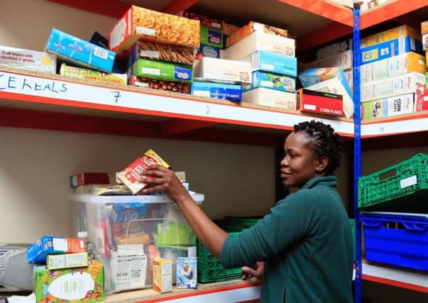 A foodbank volunteer sorting items.