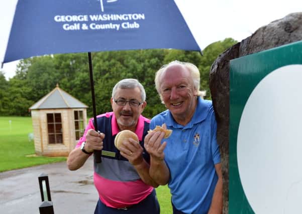 Mayoral Consort Micky Horswill (right) with Golf Operations Manager Bill Michie tucking into bacon sandwiches. Picture by FRANK REID