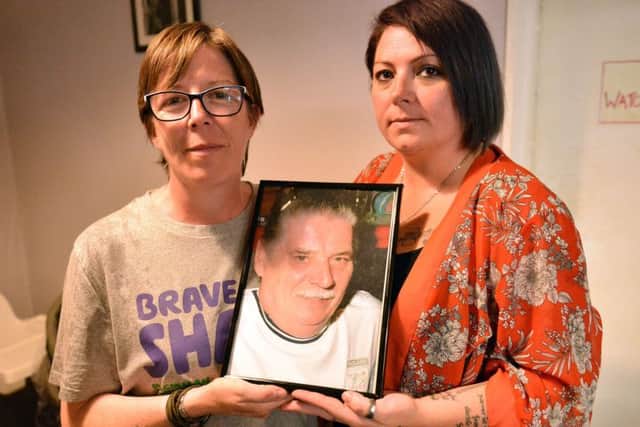 Linda Cook and her niece Deborah Adcock holding a photograph of Linda's late father John White.