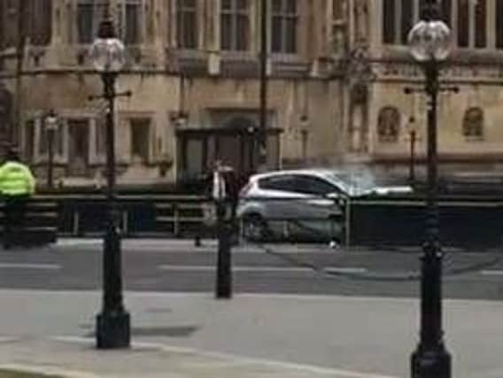 The car which crashed into security barriers outside the Houses of Parliament. Pic: Ewelina U Ochab/Twitter/PA Wire.