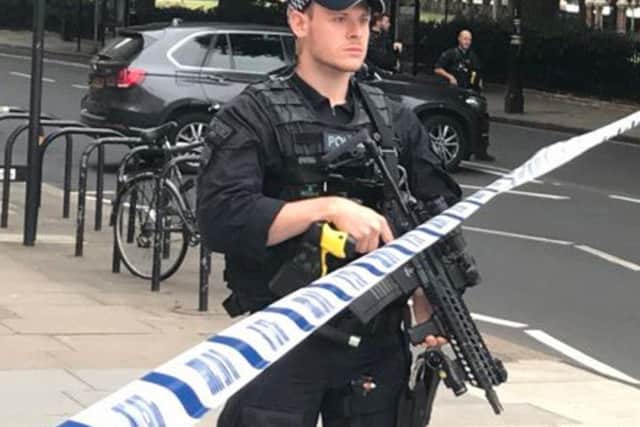 Police activity on Millbank, in central London, after a car crashed into security barriers outside the Houses of Parliament. Pic: Sam Lister/PA Wire.