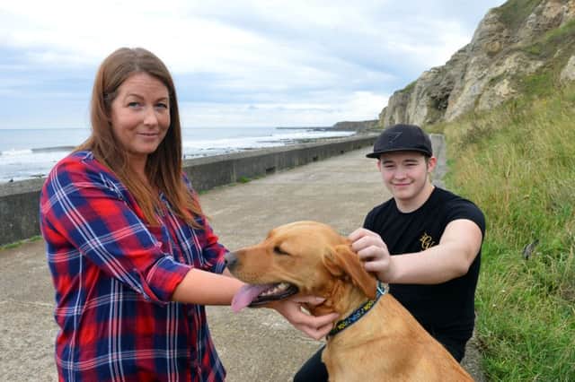 Helen McKenzie with Corey Waring and Bonnie the Labrador he saved along with his owner.