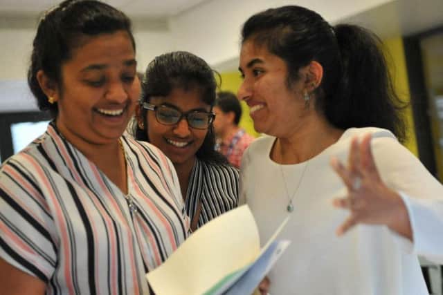 A Level student Keziah Biji (right) celebrates with her mum and sister.